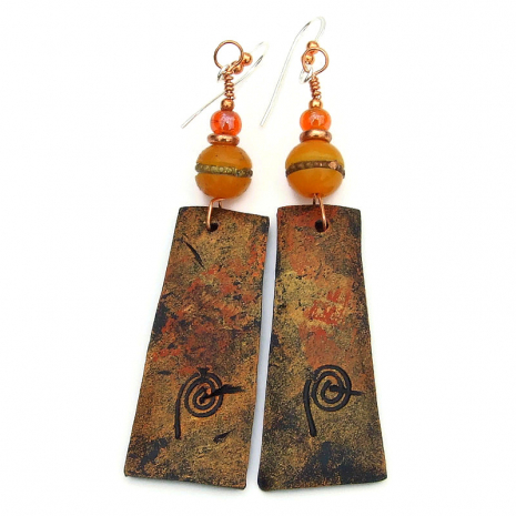 backside of klimt inspired polymer clay dangles with artists mark