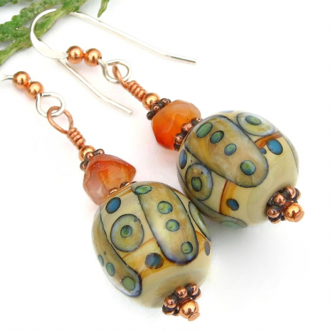handmade tribal symbols lampwork earrings orange carnelian beige green blue