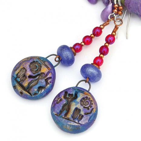 polymer clay people and spiraling sun hieroglyph earrings