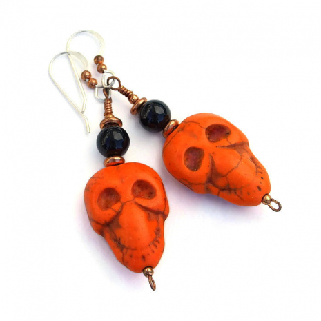 Orange and black skull earrings for Halloween.