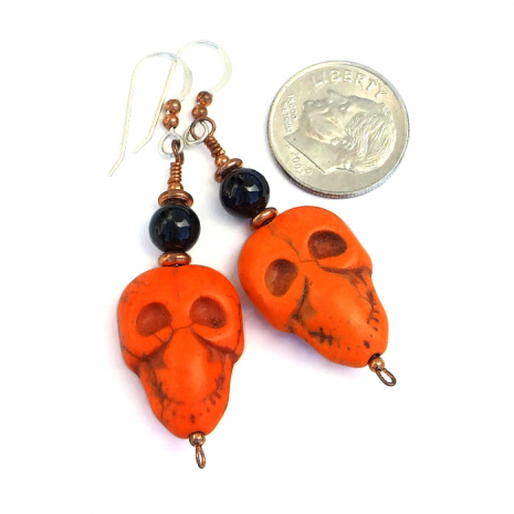 Halloween orange and black skull earrings for her.
