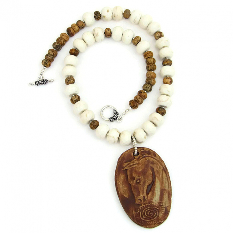 The rustic horse head and spiral totem pendant used in the Spirit Horse necklace is complemented perfectly with faceted natural magnesite and picture jasper for a Desert Southwest feel. Spirit horse pendant necklace.