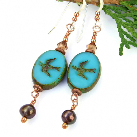 The one of a kind "Touch the Sky" handmade earrings feature turquoise blue colored Czech glass swallow beads with a Picasso finish, brown freshwater pearls, Swarovski crystals, copper and sterling silver - unique jewelry. Swallow bird earrings.