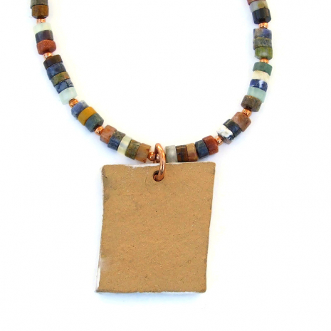 unglazed back side of ceramic horse dream pendant