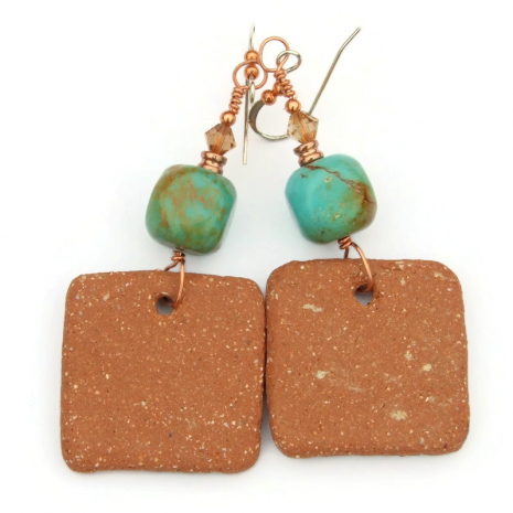unglazed back side of ceramic shaman dangles