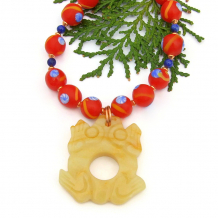The unique KATAK handmade necklace features a hand carved yellow aventurine frog pendant, Indonesian glass beads, lapis lazuli gemstones and copper - one of a kind jewelry for women. frog handmade necklace red blue yellow java glass copper