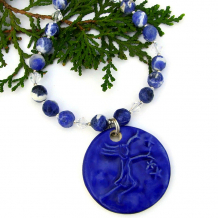 The whimsical Star Chaser handmade necklace features an artisan ceramic pendant, sodalite gemstones, white pearls and Swarovski crystals - unique jewelry for women. handmade jewelry blue star girl ceramic pendant gemstones